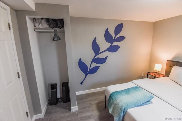 bedroom with hardwood / wood-style floors and a closet