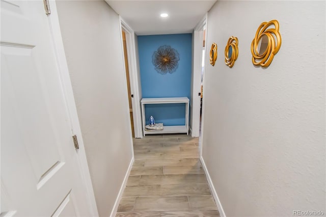 corridor with light hardwood / wood-style flooring