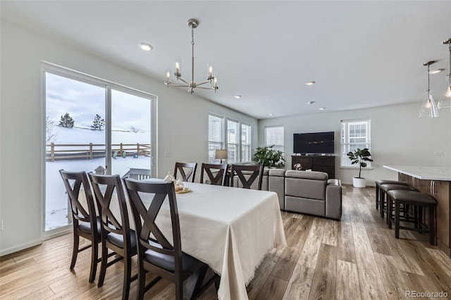 dining space with a chandelier, light wood finished floors, and recessed lighting