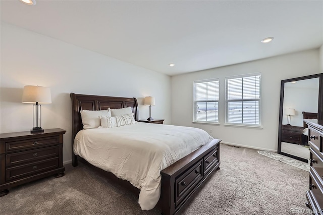 bedroom with baseboards, visible vents, and dark colored carpet