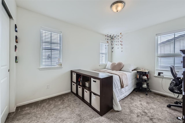 bedroom featuring carpet floors and baseboards