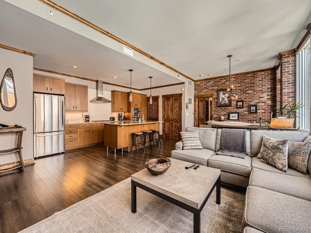 1401 Delgany St Unit 409, Denver, CO 80202 - living room featuring ornamental molding, brick wall, dark wood-style flooring, and recessed lighting