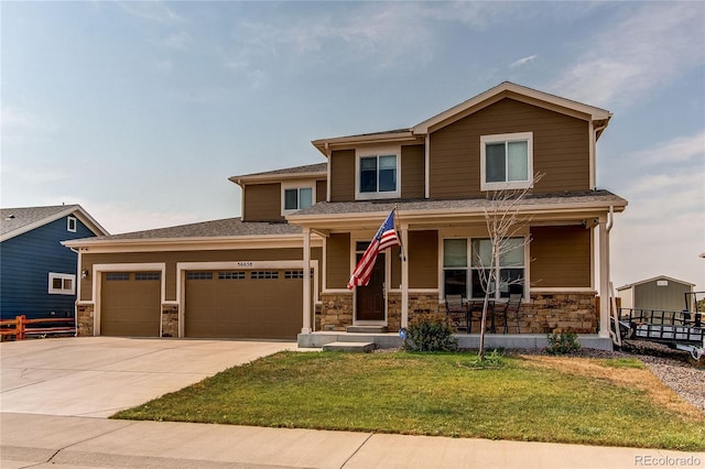 view of front facade featuring a porch, a garage, and a front yard