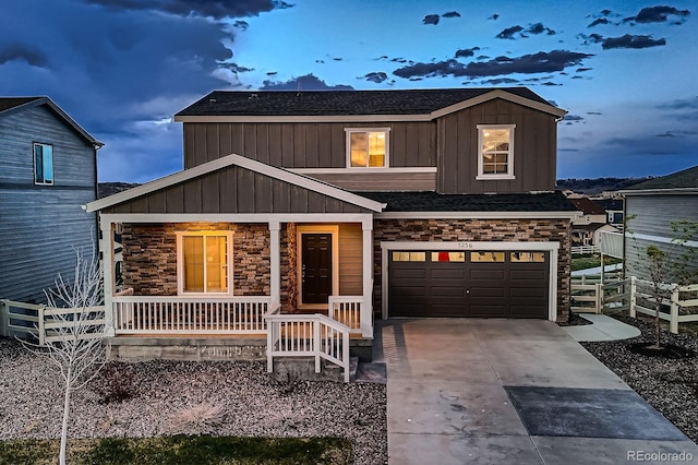5256 Trails Edge Ln, Castle Rock, CO 80104 - view of front facade with a porch, board and batten siding, concrete driveway, an attached garage, and stone siding