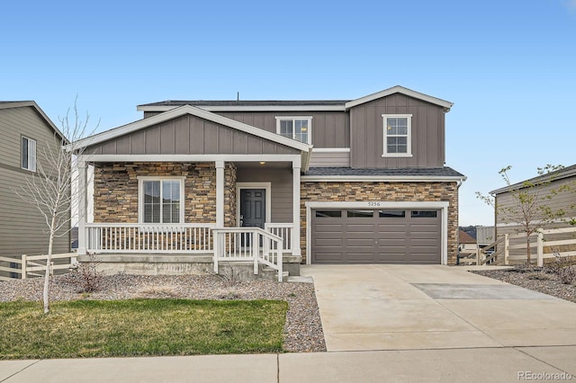 5256 Trails Edge Ln, Castle Rock, CO 80104 - craftsman house featuring covered porch, driveway, and stone siding