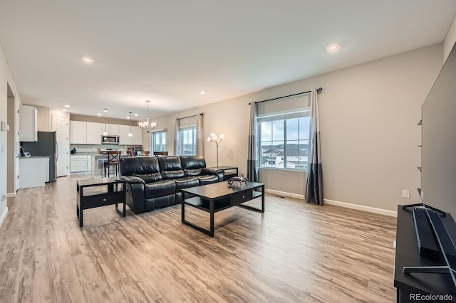 5256 Trails Edge Ln, Castle Rock, CO 80104 - living area featuring recessed lighting, baseboards, an inviting chandelier, and light wood-type flooring