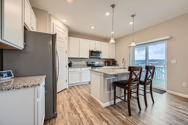 5256 Trails Edge Ln, Castle Rock, CO 80104 - kitchen with appliances with stainless steel finishes, a sink, light wood-style flooring, white cabinetry, and baseboards