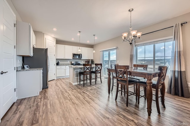 5256 Trails Edge Ln, Castle Rock, CO 80104 - dining space with recessed lighting, light wood-style flooring, and a notable chandelier