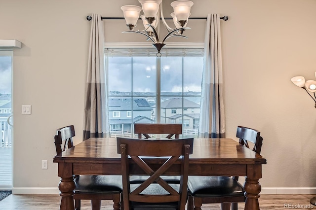 5256 Trails Edge Ln, Castle Rock, CO 80104 - dining room with baseboards, wood finished floors, and a notable chandelier