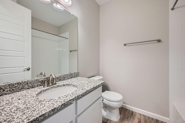 5256 Trails Edge Ln, Castle Rock, CO 80104 - bathroom featuring toilet, baseboards, wood finished floors, and vanity