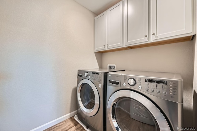 5256 Trails Edge Ln, Castle Rock, CO 80104 - washroom featuring baseboards, light wood-type flooring, cabinet space, and washing machine and clothes dryer