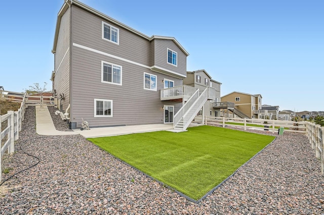 5256 Trails Edge Ln, Castle Rock, CO 80104 - back of property with a deck, a patio area, a fenced backyard, a yard, and stairs