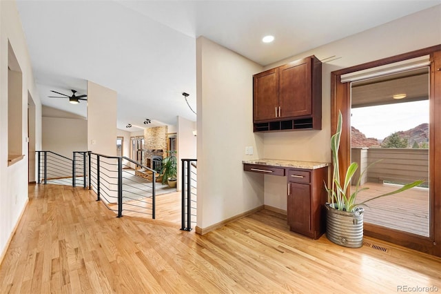 interior space featuring light hardwood / wood-style floors and lofted ceiling