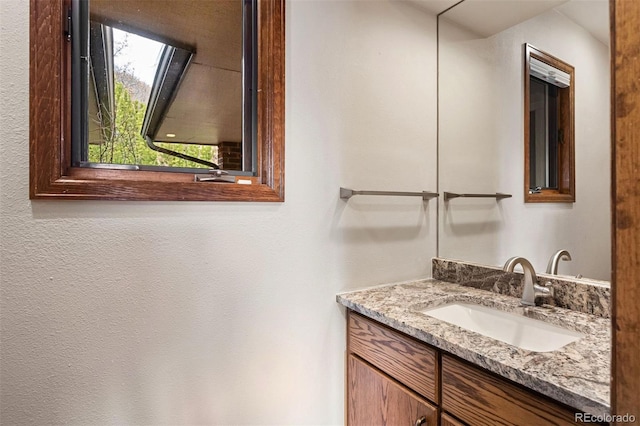 bathroom featuring vanity and a skylight