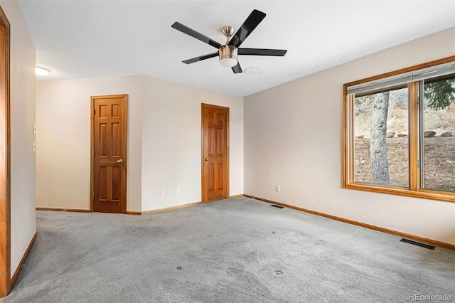 unfurnished room with carpet floors and ceiling fan