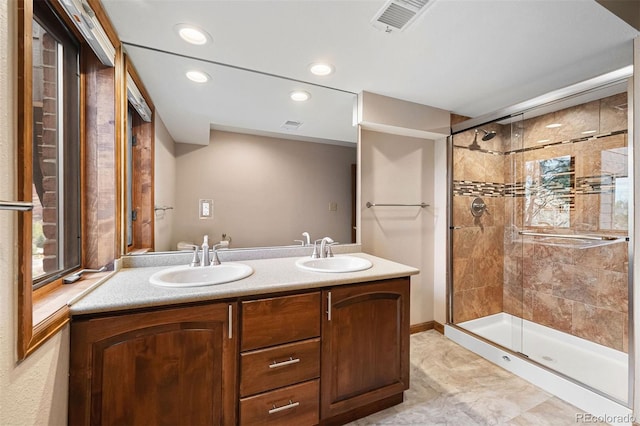 bathroom featuring vanity and an enclosed shower