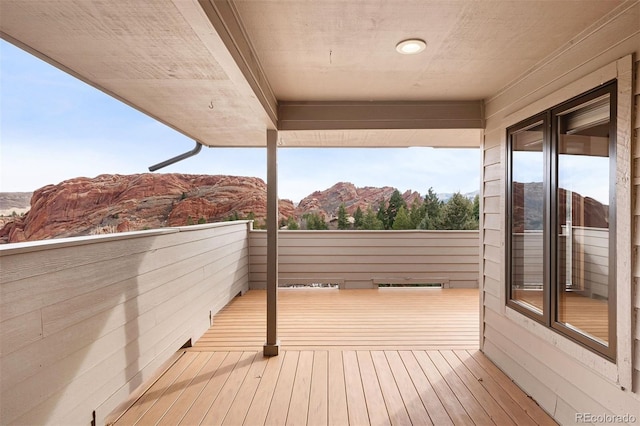 wooden deck with a mountain view