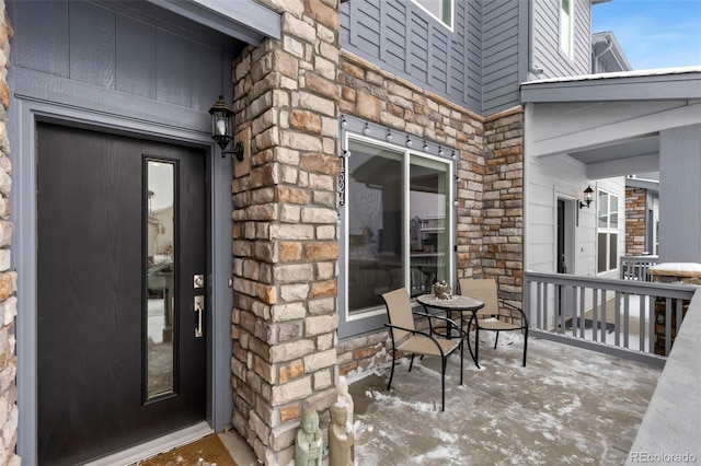 view of exterior entry featuring covered porch