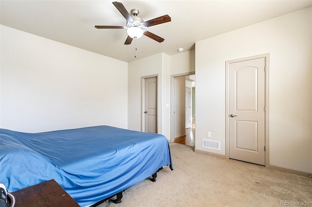 carpeted bedroom with ceiling fan