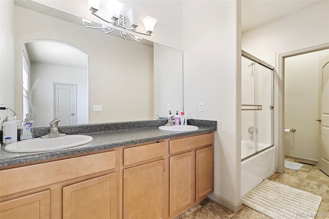 bathroom featuring vanity and shower / bath combination with glass door