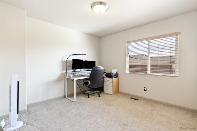 office space featuring light carpet and heating unit