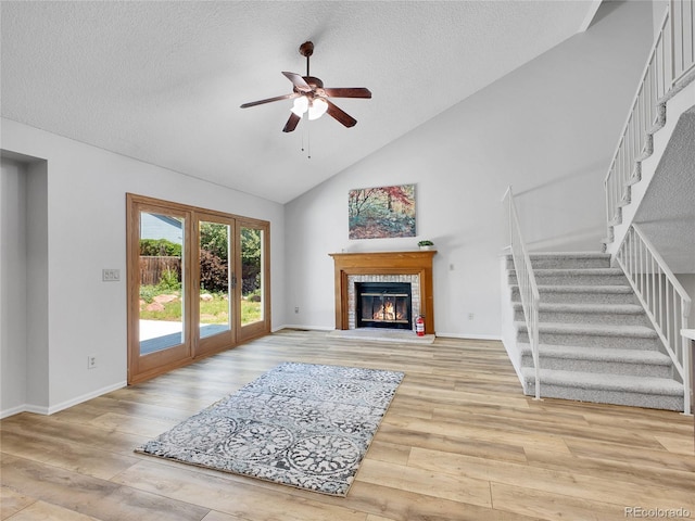 655 Gooseberry Ct, Lafayette, CO 80026 - unfurnished living room with stairway, ceiling fan, wood finished floors, a fireplace, and a textured ceiling