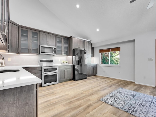 655 Gooseberry Ct, Lafayette, CO 80026 - kitchen featuring appliances with stainless steel finishes, light countertops, backsplash, light wood-style flooring, and recessed lighting
