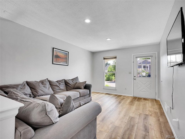 655 Gooseberry Ct, Lafayette, CO 80026 - living area featuring light wood finished floors, a textured ceiling, and recessed lighting