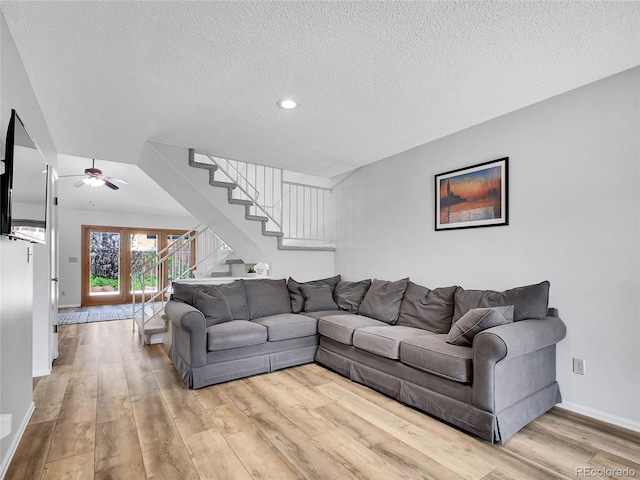 655 Gooseberry Ct, Lafayette, CO 80026 - living room featuring a textured ceiling, light wood-style floors, a ceiling fan, stairs, and recessed lighting