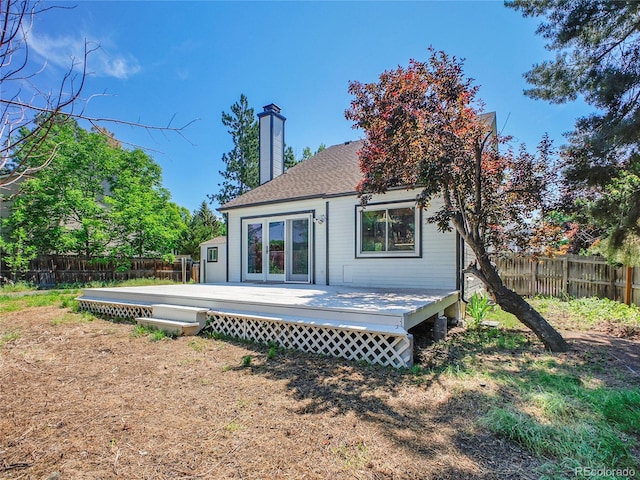 655 Gooseberry Ct, Lafayette, CO 80026 - rear view of house featuring a fenced backyard, a chimney, a deck, and french doors