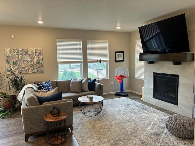 12901 Crane River Dr, Longmont, CO 80504 - living room featuring wood finished floors, a fireplace, baseboards, and recessed lighting