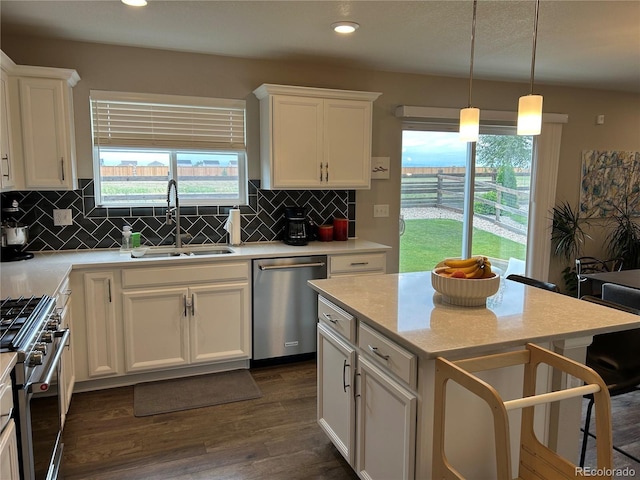 12901 Crane River Dr, Longmont, CO 80504 - kitchen featuring stainless steel appliances, dark wood-type flooring, white cabinets, and a sink
