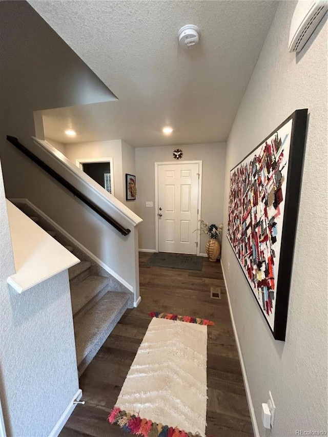 12901 Crane River Dr, Longmont, CO 80504 - entrance foyer featuring stairs, a textured ceiling, baseboards, and wood finished floors