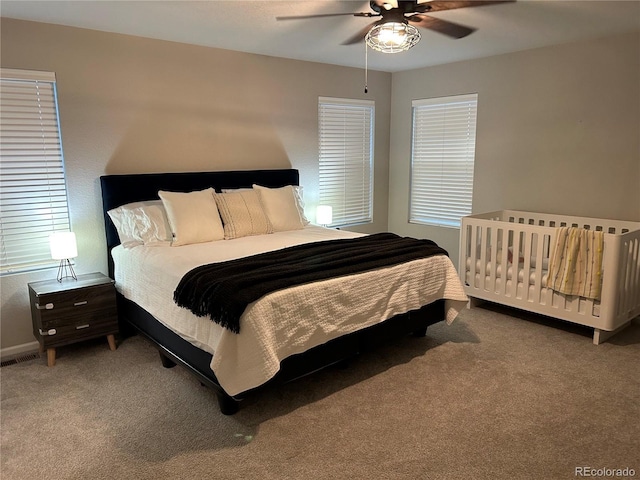 12901 Crane River Dr, Longmont, CO 80504 - bedroom featuring carpet, visible vents, baseboards, and a ceiling fan