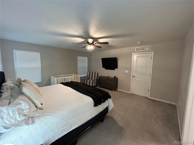12901 Crane River Dr, Longmont, CO 80504 - carpeted bedroom featuring visible vents, baseboards, and ceiling fan