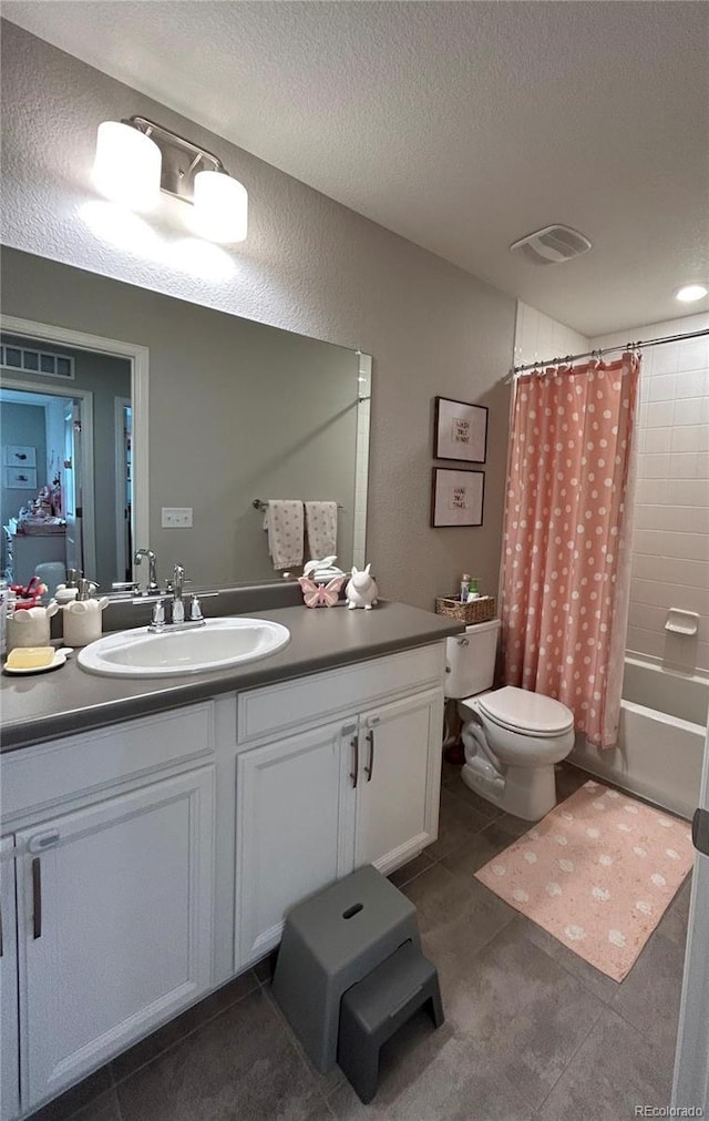 12901 Crane River Dr, Longmont, CO 80504 - bathroom with vanity, tile patterned floors, a textured ceiling, toilet, and visible vents