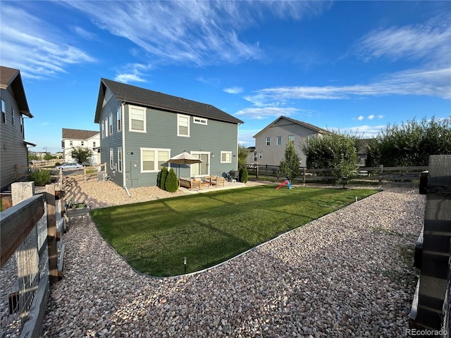 12901 Crane River Dr, Longmont, CO 80504 - rear view of house featuring a patio area, a fenced backyard, and a yard