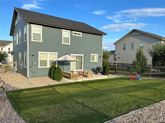 12901 Crane River Dr, Longmont, CO 80504 - rear view of house with outdoor lounge area, a patio area, a fenced backyard, and a lawn