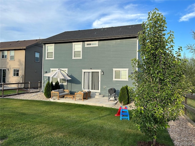 12901 Crane River Dr, Longmont, CO 80504 - back of house featuring a patio area, a fenced backyard, outdoor lounge area, and a lawn