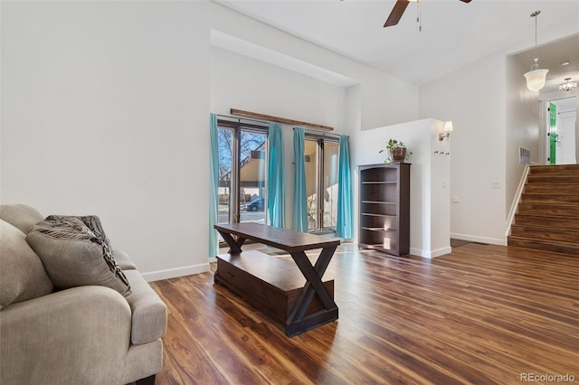 interior space featuring a high ceiling, dark hardwood / wood-style flooring, and ceiling fan