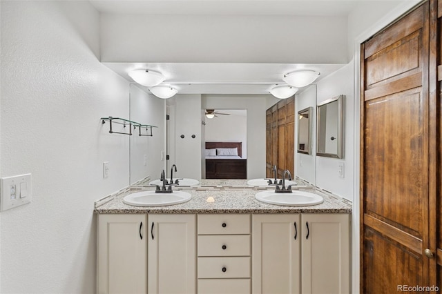 bathroom with ceiling fan and vanity