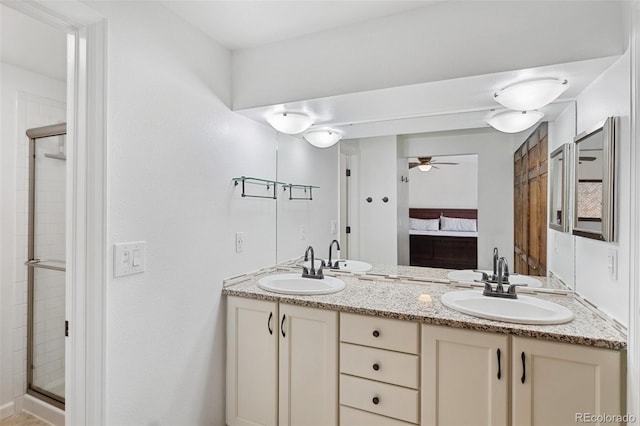 bathroom featuring ceiling fan, vanity, and a shower with shower door