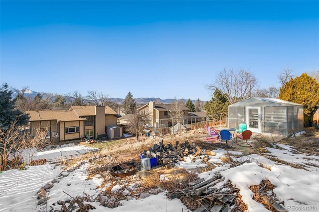 yard covered in snow with an outbuilding