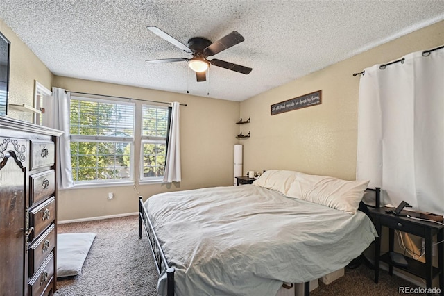 bedroom with dark colored carpet, a textured ceiling, and ceiling fan