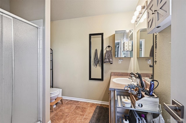 bathroom featuring walk in shower, vanity, and toilet