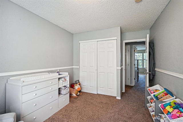 rec room with dark carpet and a textured ceiling