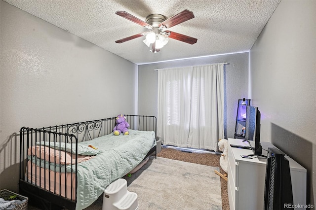 bedroom with a textured ceiling, ceiling fan, and light colored carpet