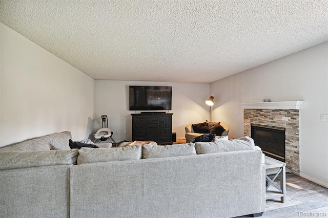 living room featuring a fireplace and a textured ceiling