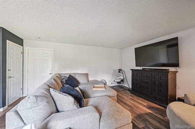 living room with dark wood-type flooring and a textured ceiling