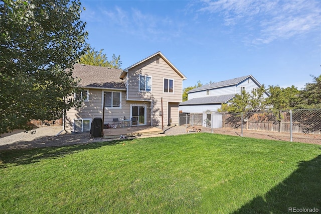 back of house featuring a storage unit, a yard, and a patio area